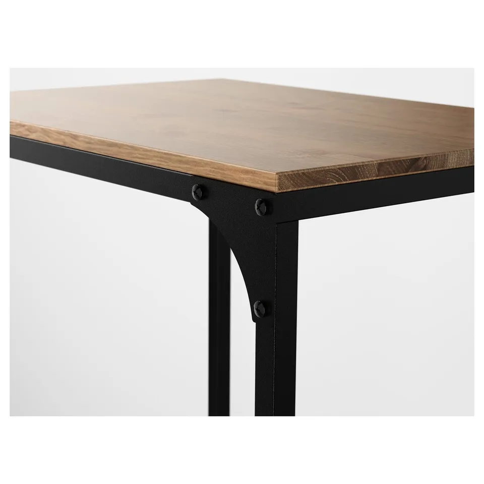 Wooden tabletop with black metal legs. Detailed craftsmanship shown in grain and finish.