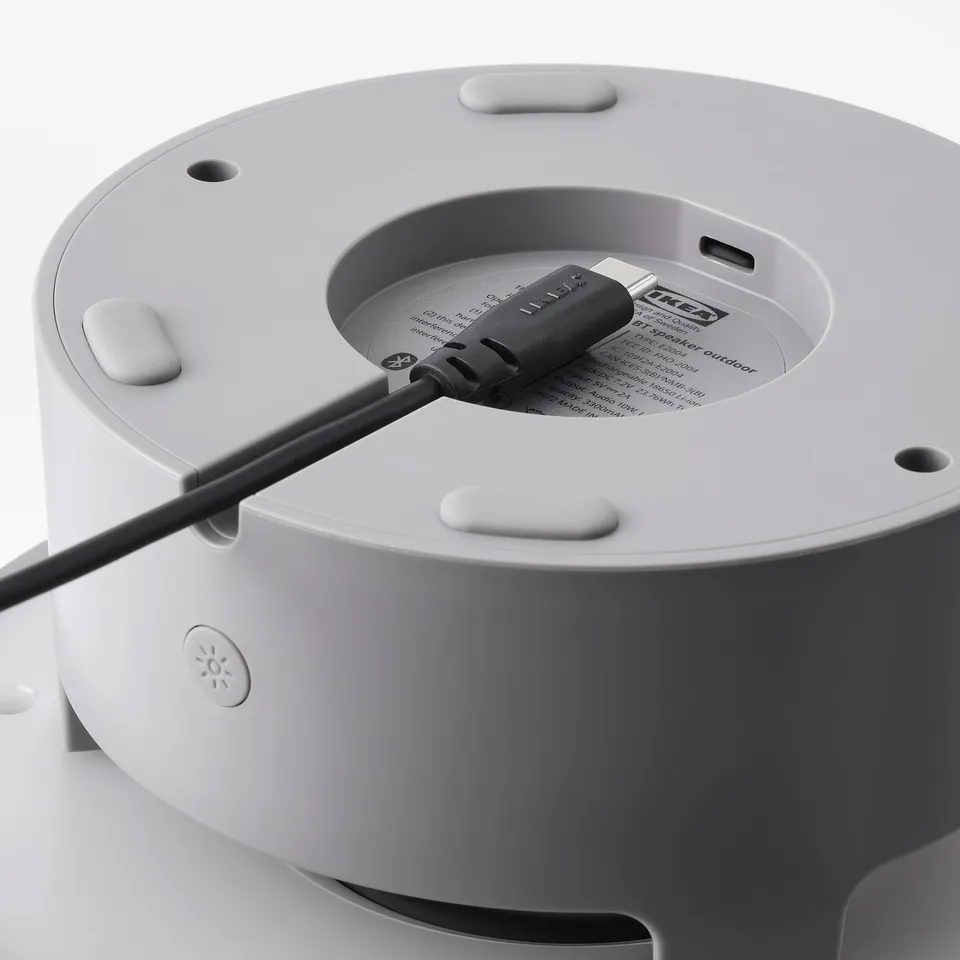 A portable speaker with a built-in lamp and charging port. Ideal for outdoor use, featuring bluetooth connectivity and a rainproof design.
