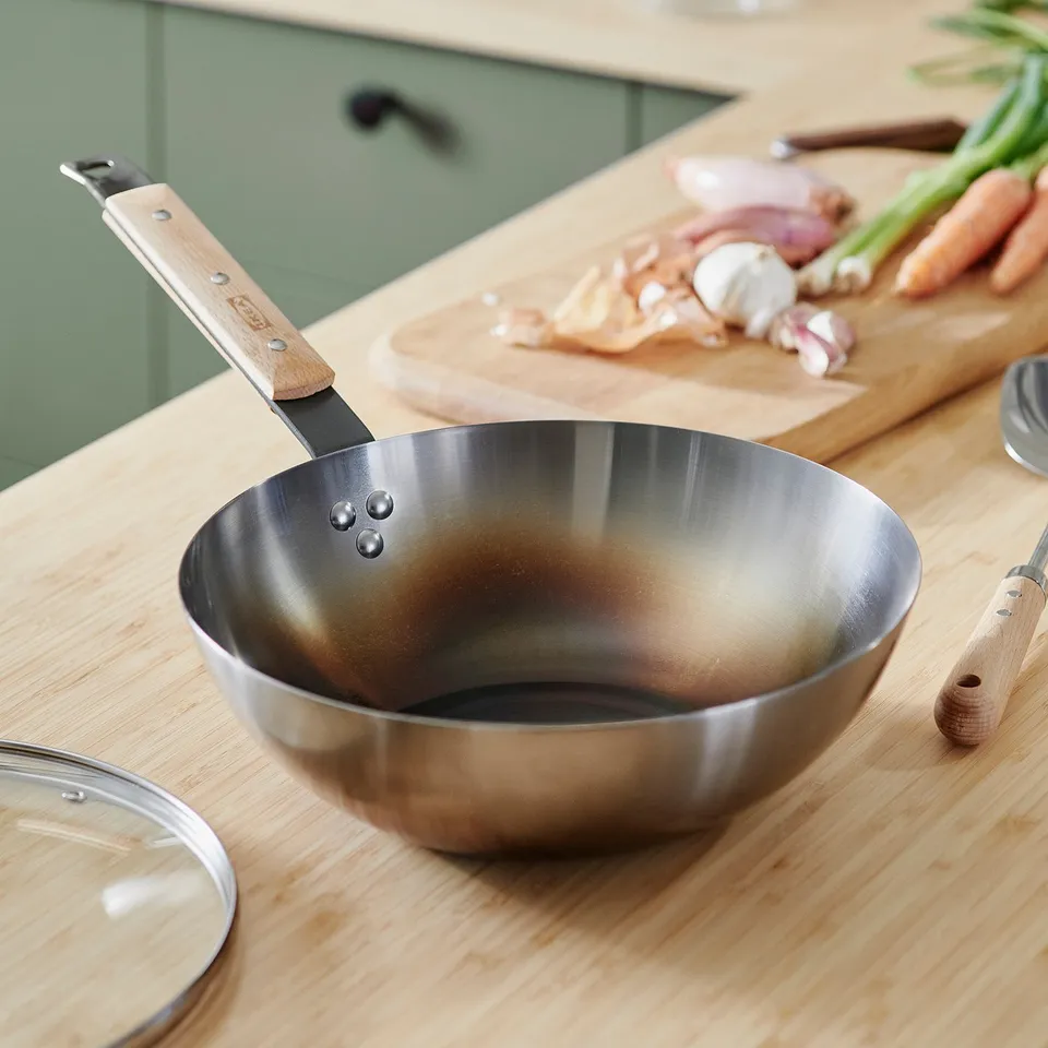 Empty wok on counter, ready for cooking.