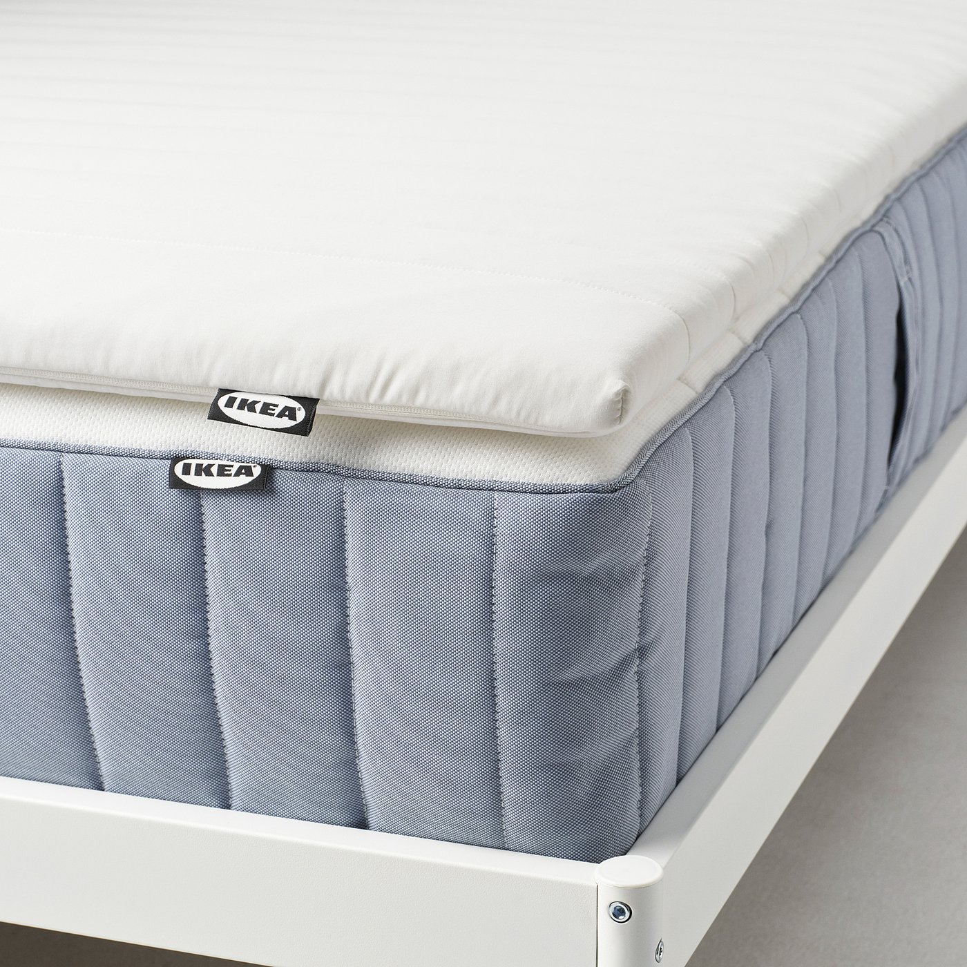 Ikea mattress pad shown, featuring double-sided comfort with washable cover.