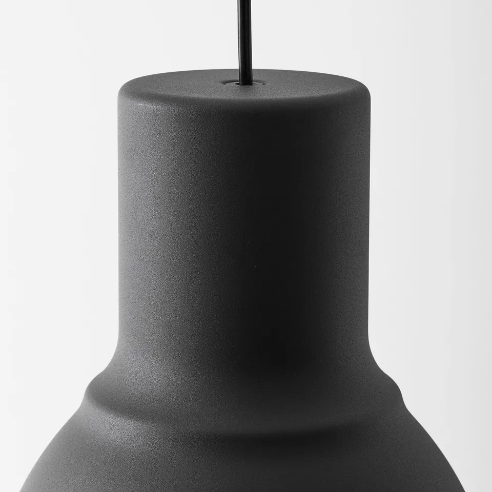 Close-up of black modern lamp; smooth, sleek finish; robust design.