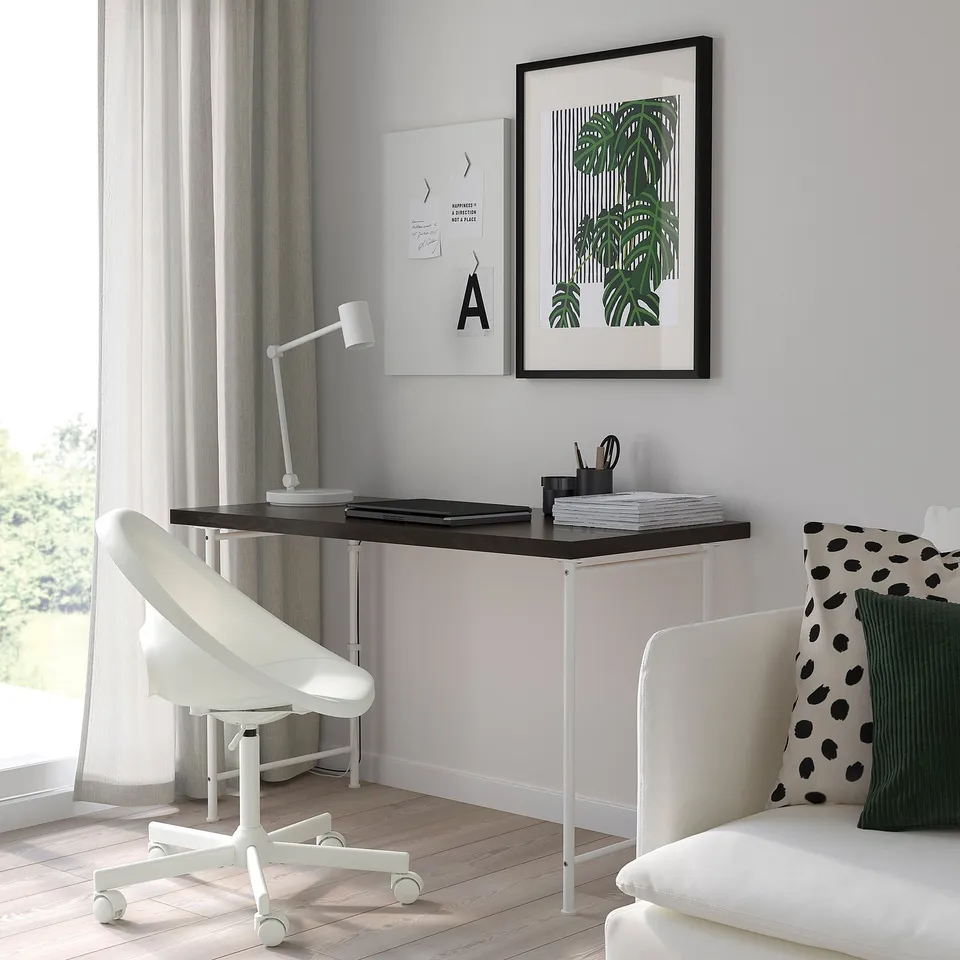 Minimalist home office with white LAGKAPTEN desk, chair, lamp, and green decor, ideal for study/work.