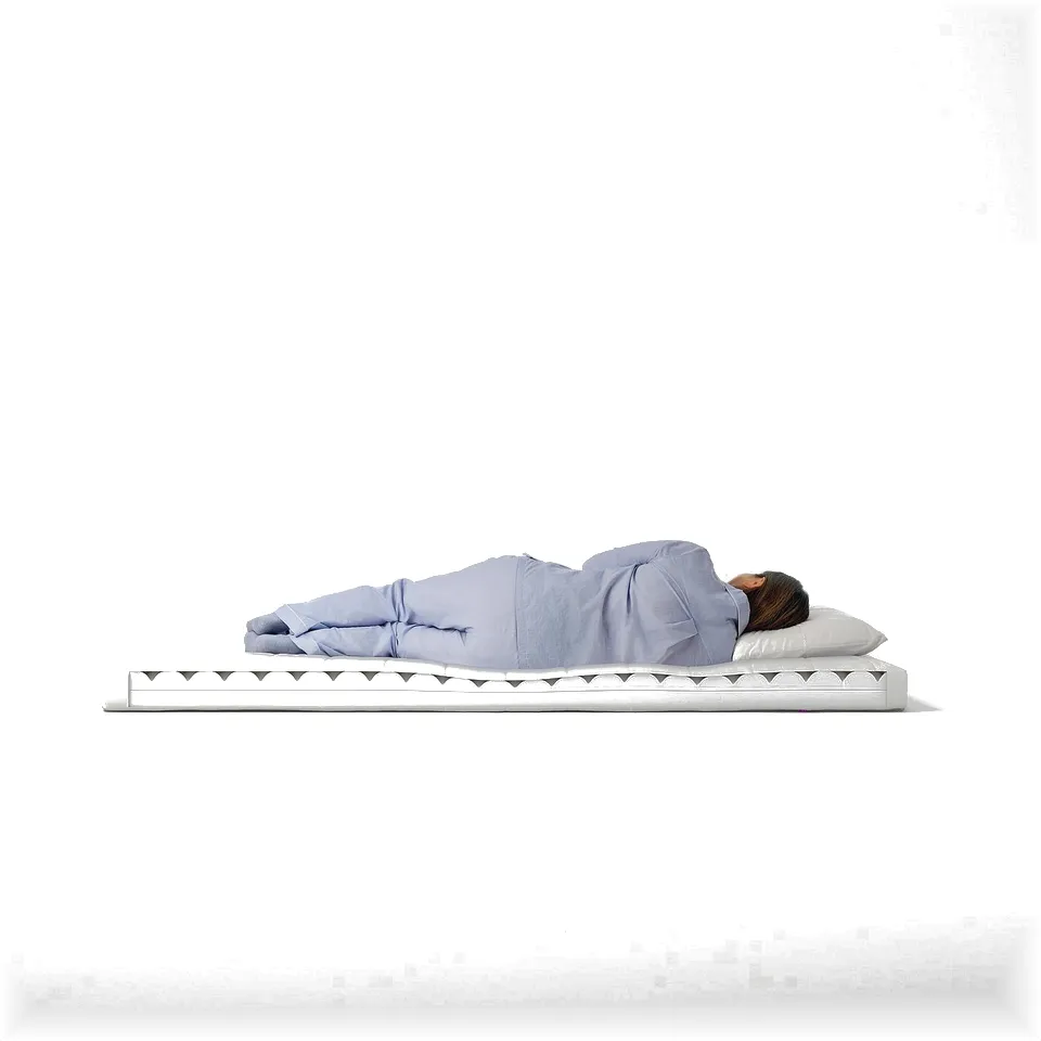 Person in light blue sleepwear sleeps on white, rectangular foam mattress with triangular pattern edge.