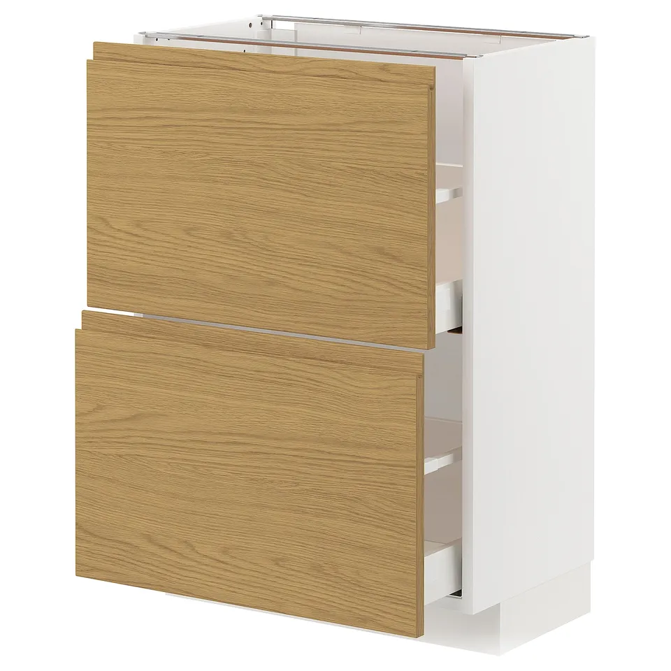 A METOD kitchen unit with oak-colored drawer fronts and white cabinet sides. It has a sleek, minimalist design with integrated handles.