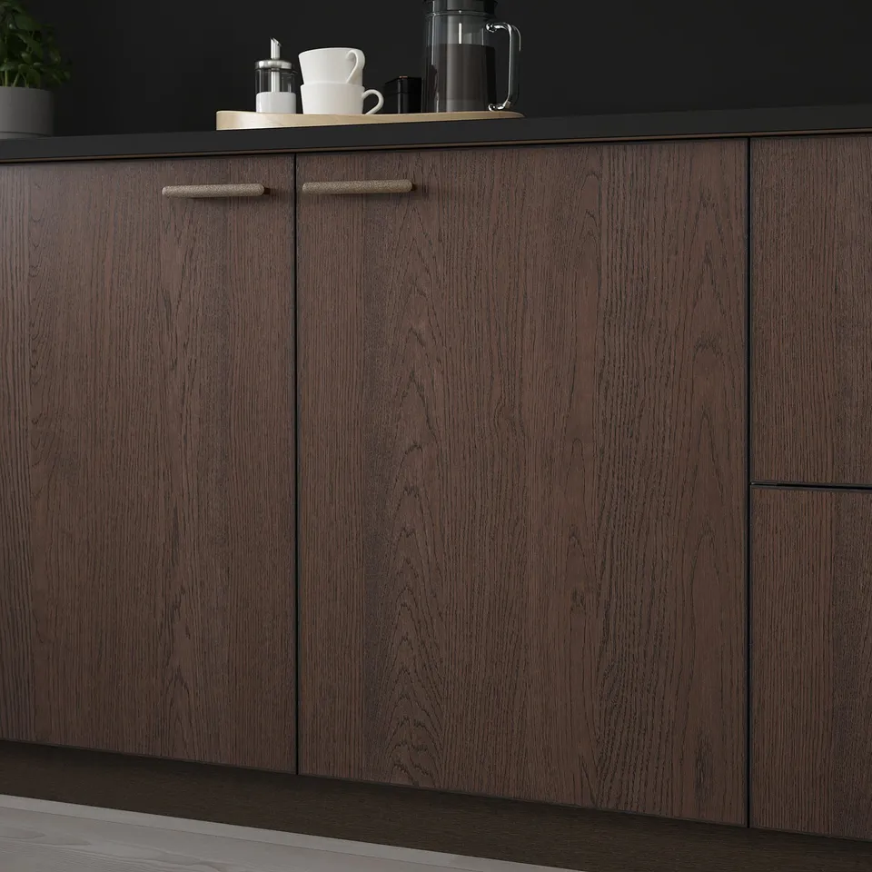 Dark wood kitchen cabinet with metal handles, showcasing modern design and durability.