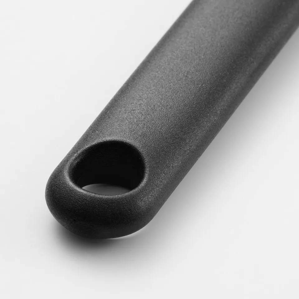 Black grill brush with a round handle and silicone bristles, designed for even liquid application.