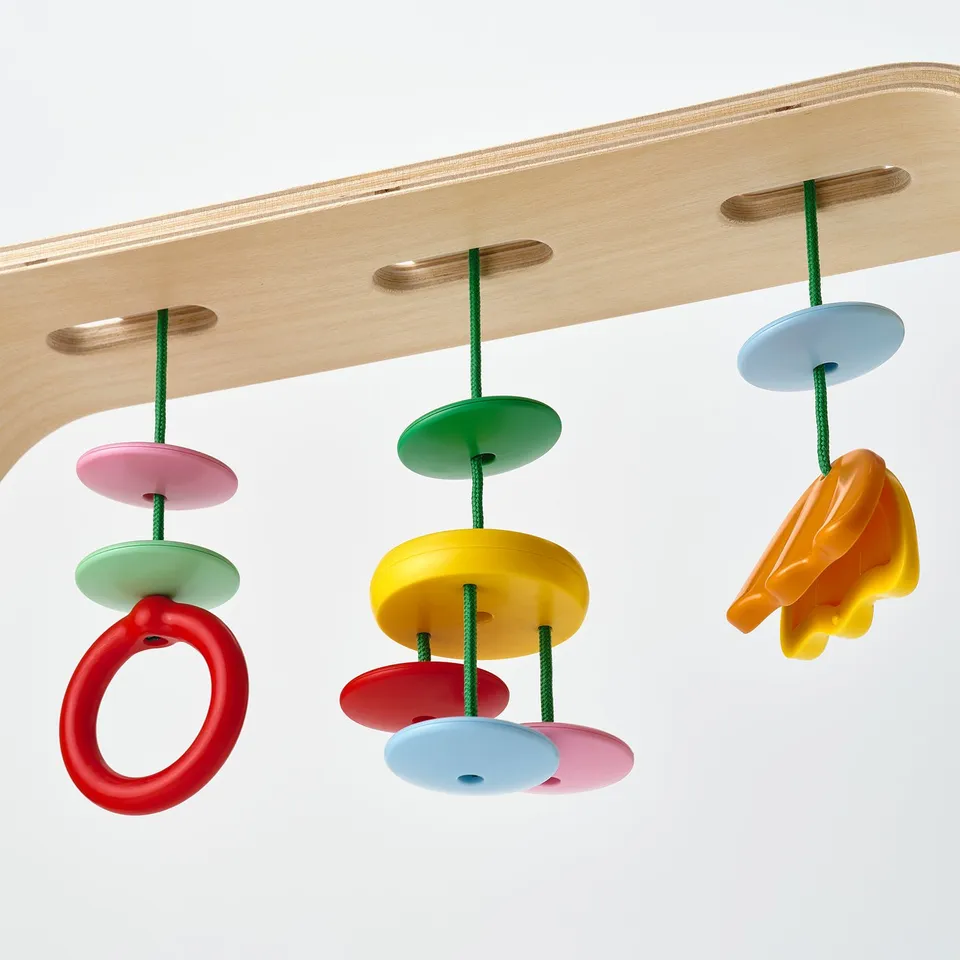 Baby gym with wooden arch and colourful hanging toys to enhance eye-hand coordination and visual recognition.