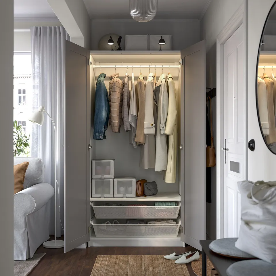 Open closet displaying coats; includes shelves and drawers. Integrated lighting illuminates the interior.