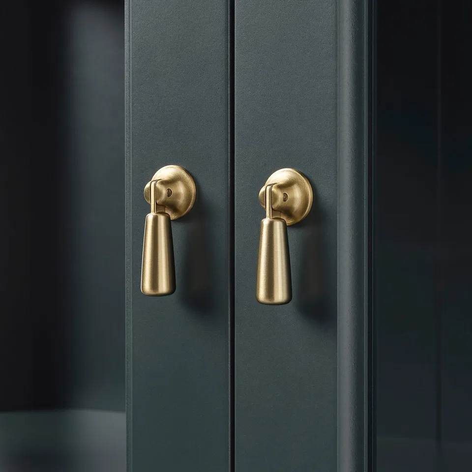 Dark wooden cabinet with gold handles, featuring two doors. Soft-close mechanism ensures smooth operation.