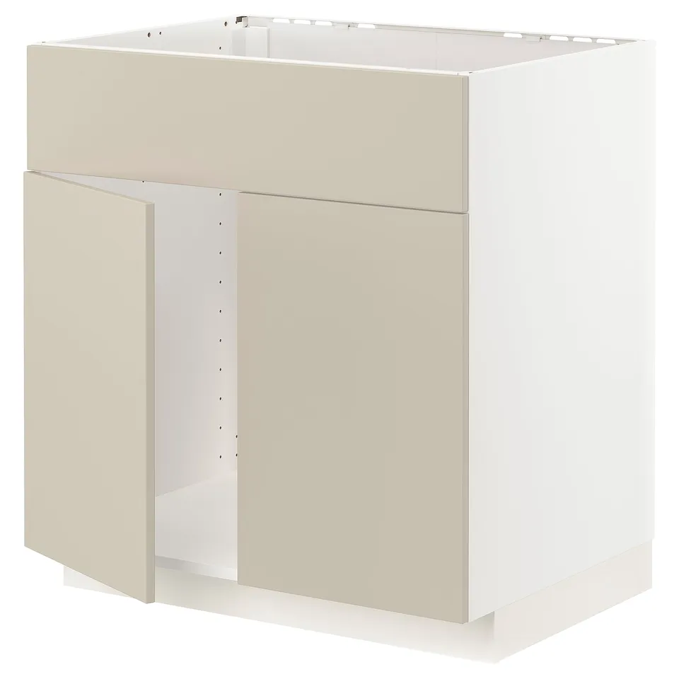 A beige METOD kitchen cabinet with a white interior. It has a rectangular shape with one open door.