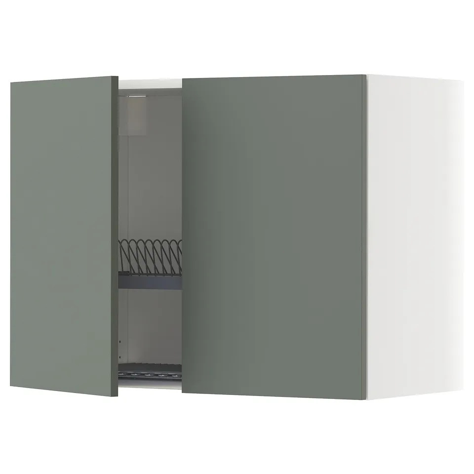 A green-grey METOD kitchen cabinet with one door open, revealing an adjustable shelf and a steel dish drainer.