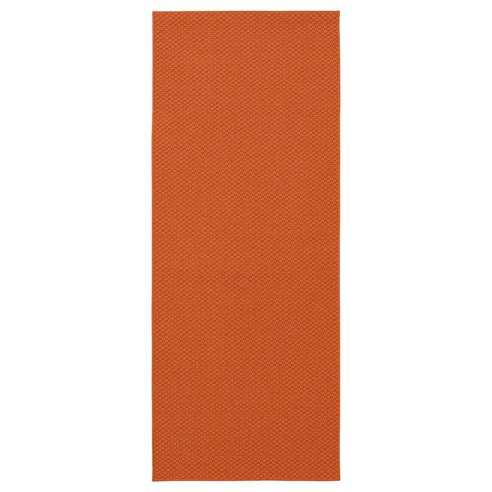 Orange rectangular rug with subtle textured pattern.