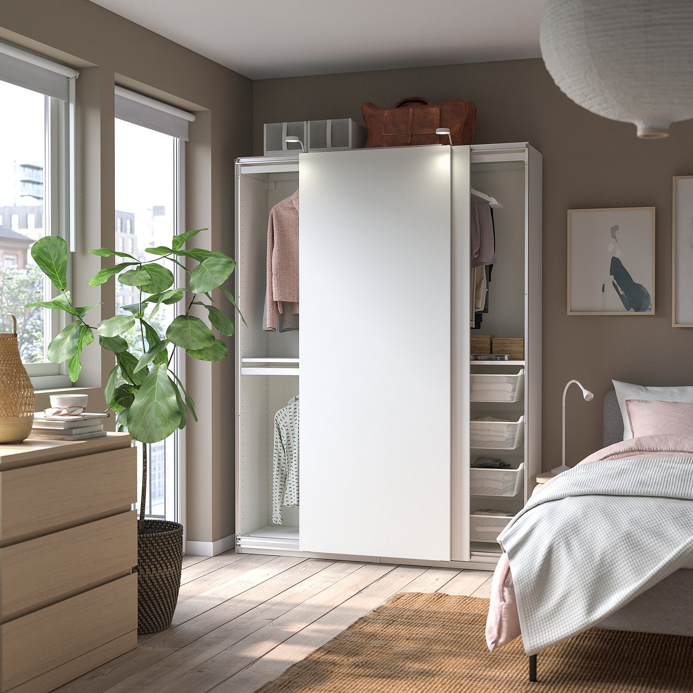 Modern bedroom with white PAX wardrobe, wooden drawers, large plant, and cosy bed.