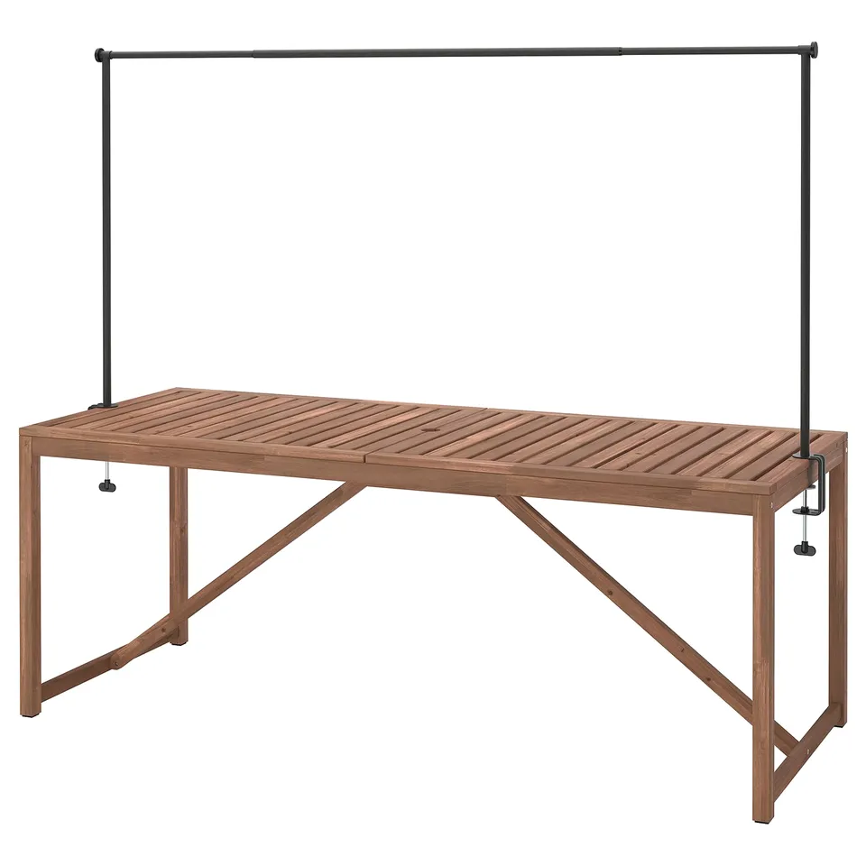 NÄMMARÖ outdoor table, wood. Rectangular, light brown, metal legs, slatted top, with attached decorating rod.
