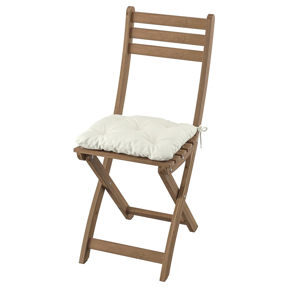 Wooden folding chair with white cushion, simple, light brown colour, padded seat for comfort.