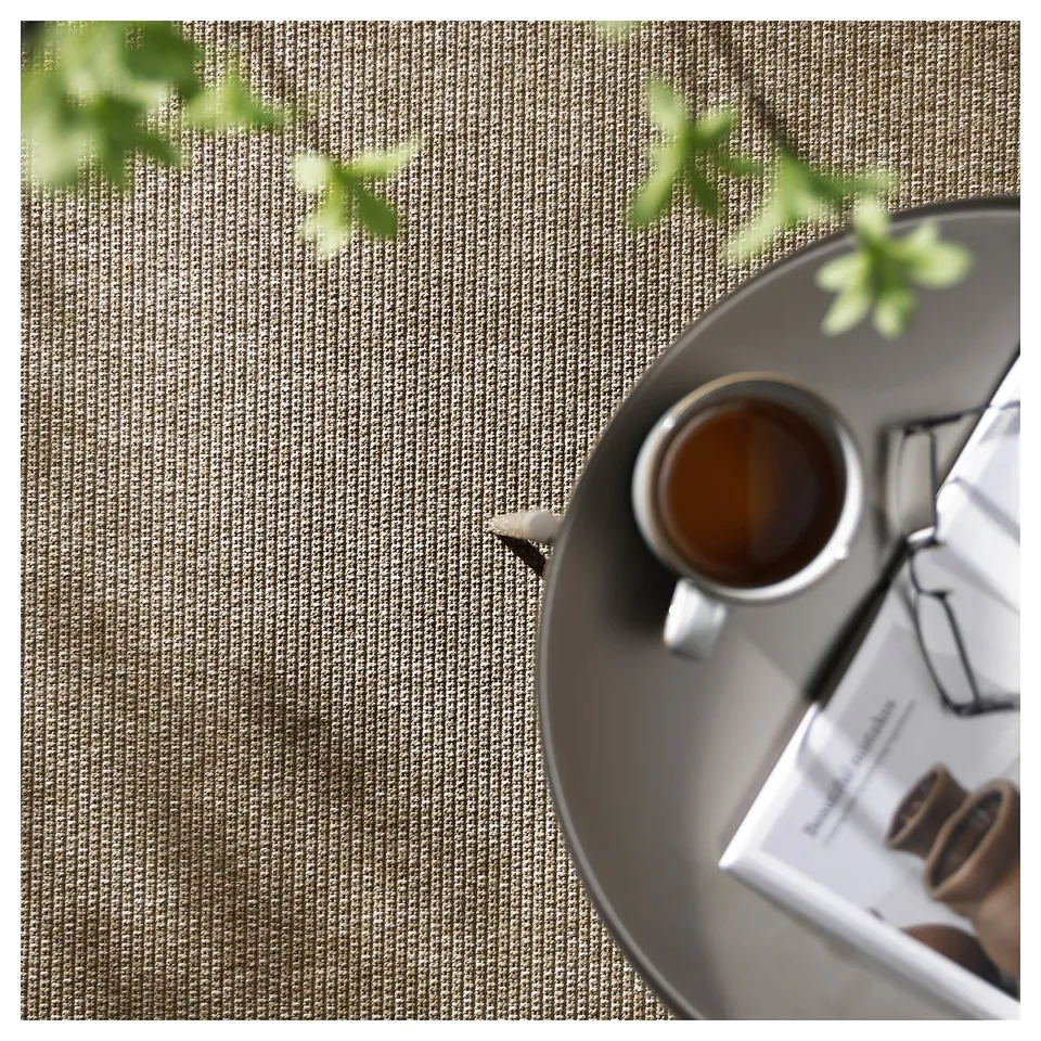 Beige flatwoven rug for indoor/outdoor use, textured pattern.