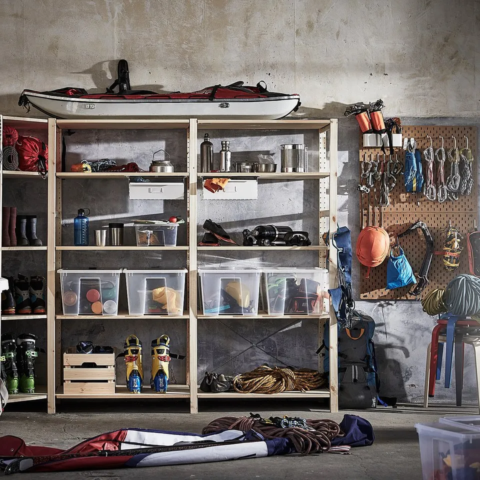 Shelves with sports gear, camping equipment, and tools.