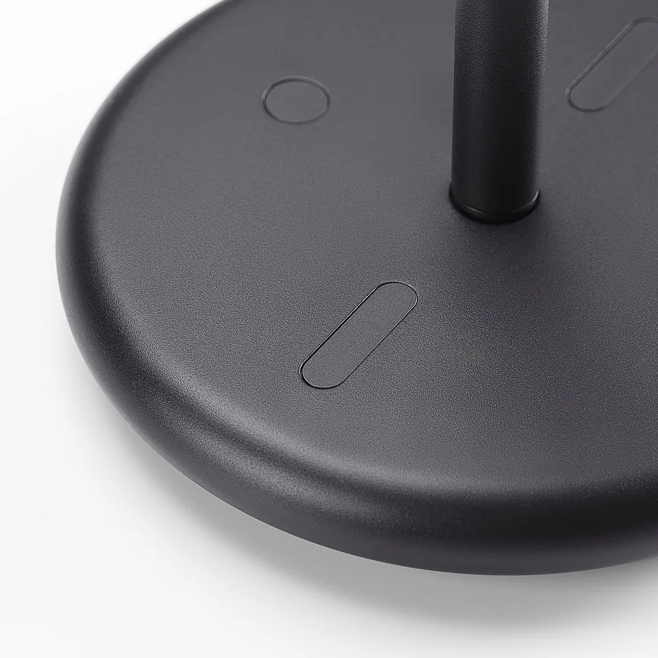 Black circular base of stylish table mirror with smooth texture and subtle design details.