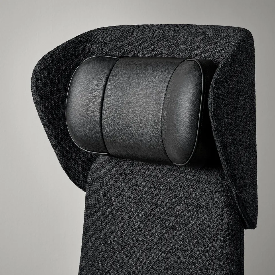 Ergonomic office chair close-up, featuring adjustable headrest and lumbar support for comfort.