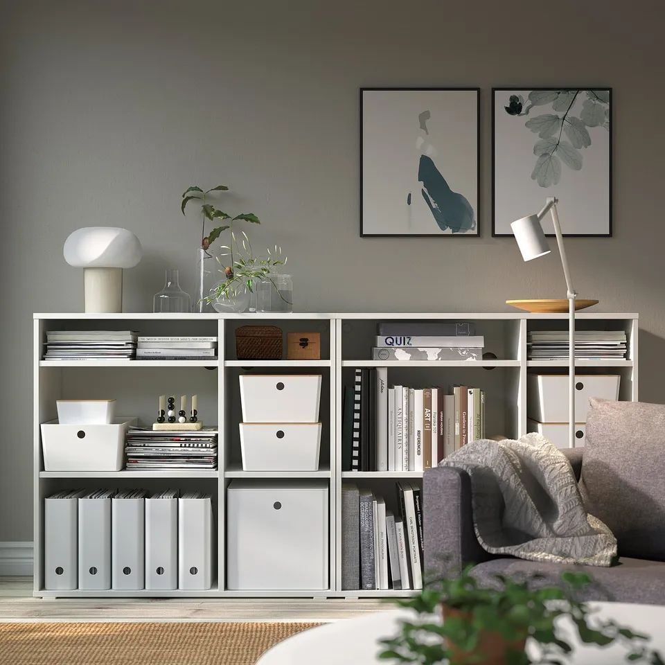 Cosy living room with grey storage, art, and comfy couch.