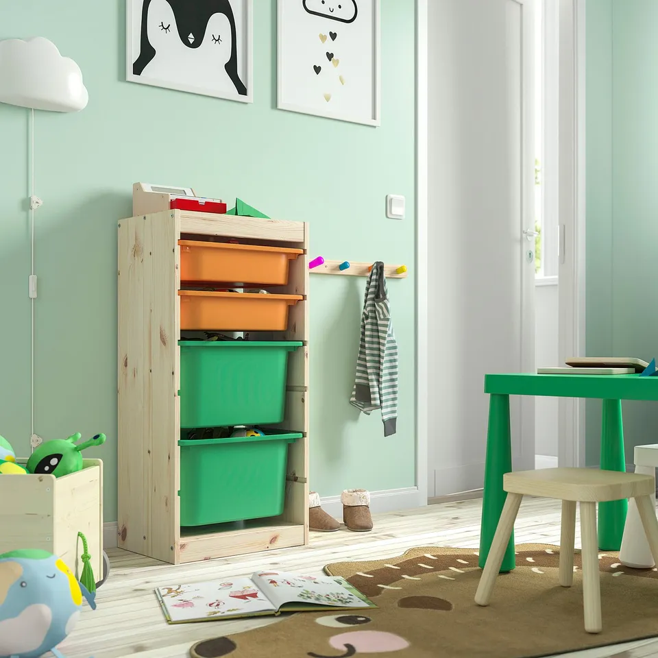 Childs room with TROFAST storage unit, light wood, multiple green bins, low to floor. Bright, colourful decor.