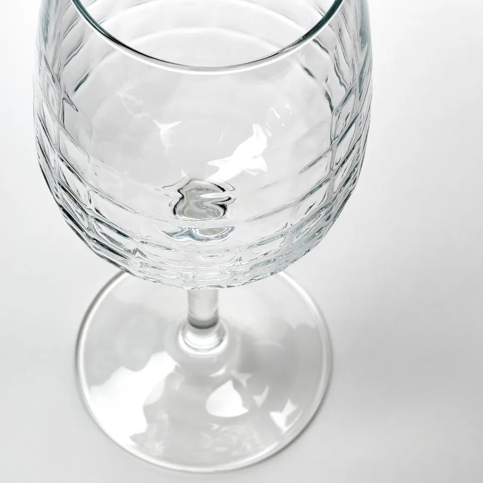 Faceted wine glass, clear glass, elegant design.