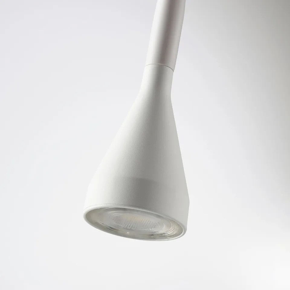 White pendant lamp with adjustable neck, emitting soft light, clamped securely.