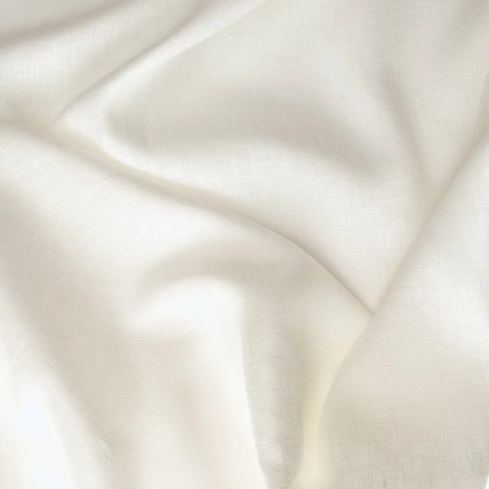Soft, white crushed linen curtain close-up, showcasing texture and quality.