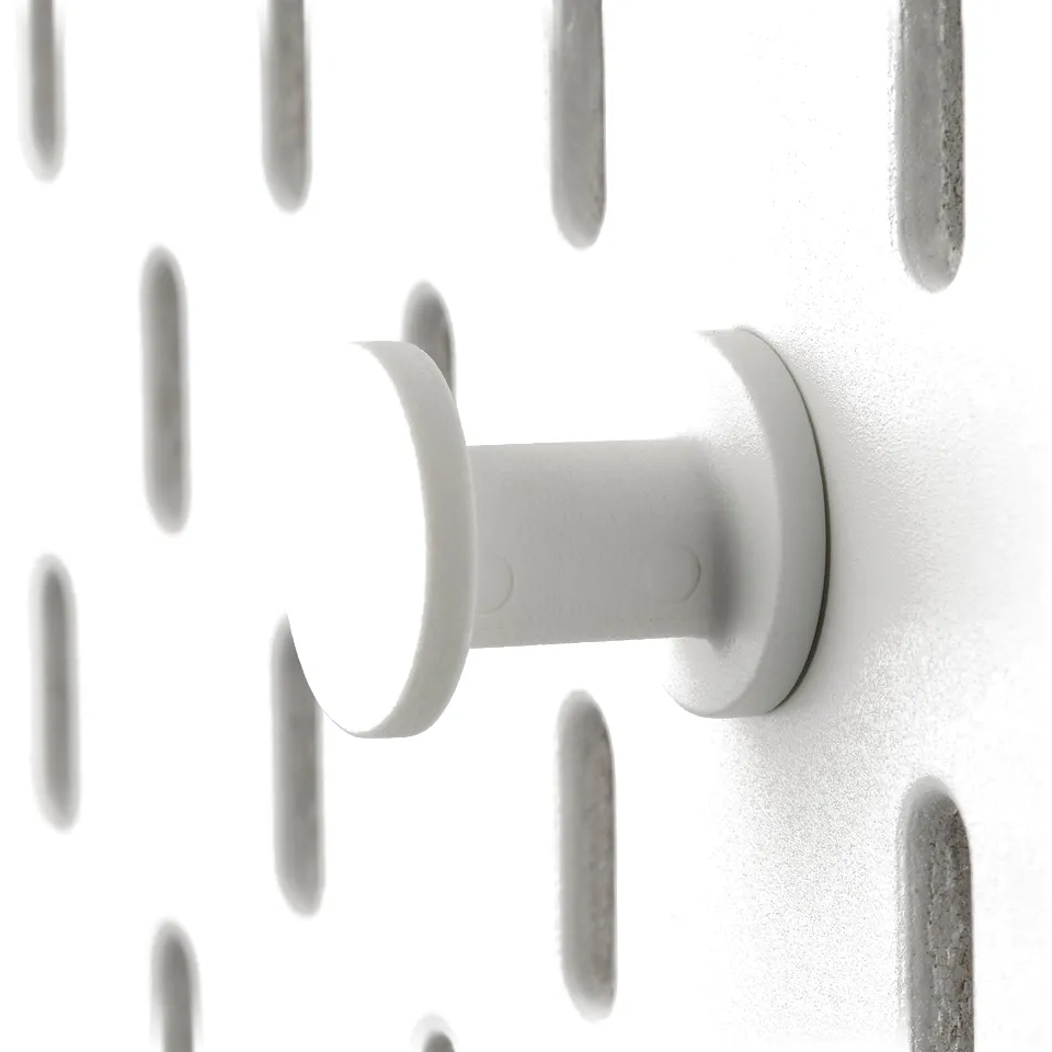 Crafter white plastic wall hook. Affixed to patterned wall, sturdy design.