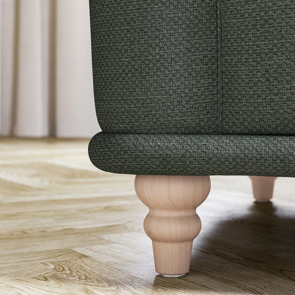VISKAFORS green armchair, dark wood legs, soft rounded shape.