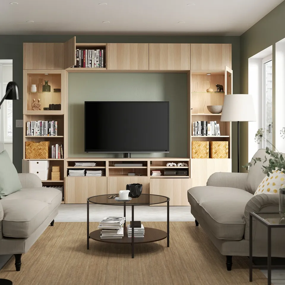 Modern living room with light-colored wooden tv unit featuring adjustable shelves and hidden cable organisation.