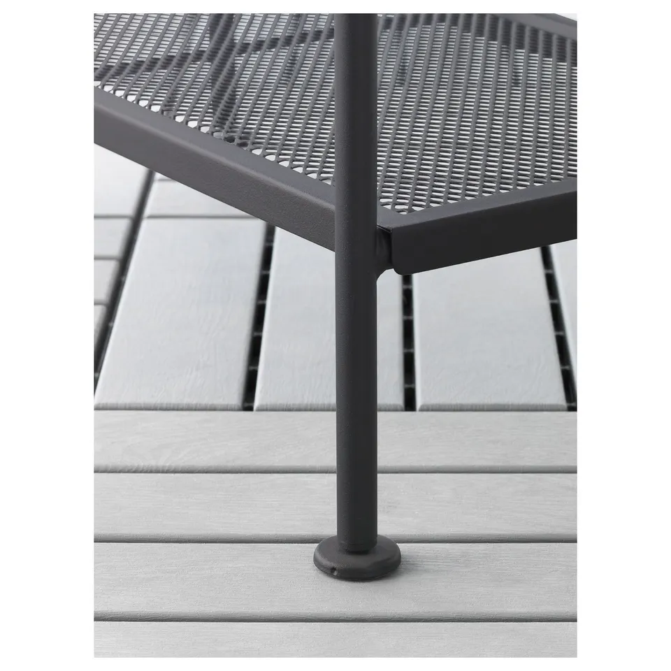 Modern metal bench with perforated seat, sturdy legs, and non-slip feet on patio deck.