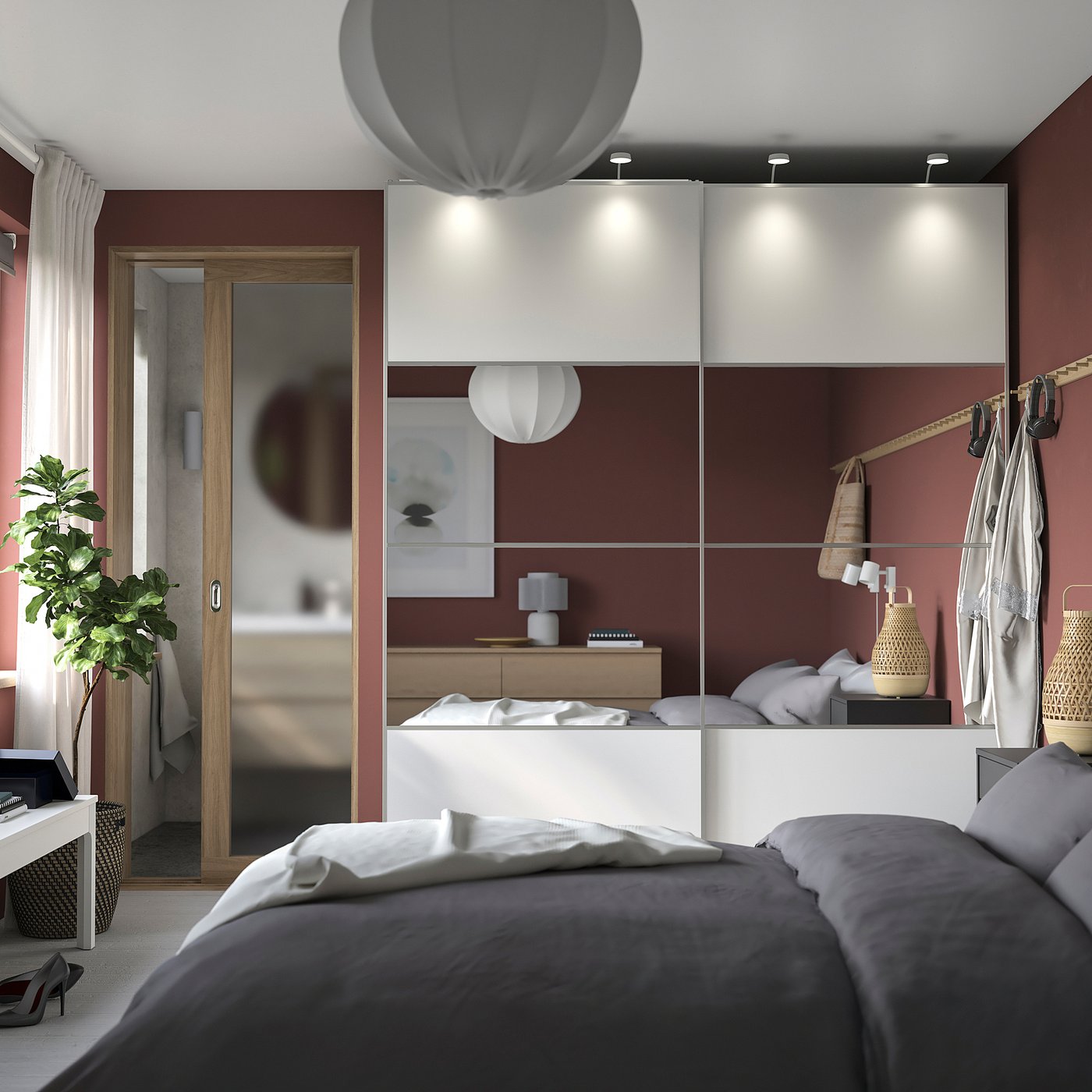 Modern bedroom with grey bed, white PAX wardrobe, red walls, and hanging light fixtures.