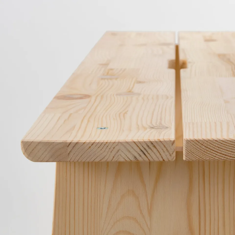 Aboration of fine wooden table edge, showing natural grains and craftsmanship.