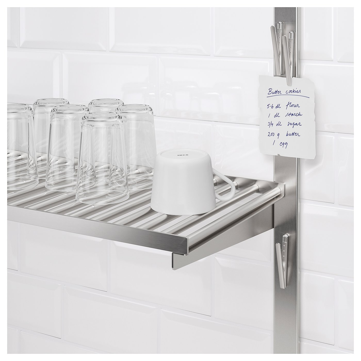 Kitchen shelf with clear glasses and a recipe note held by magnetic clips.
