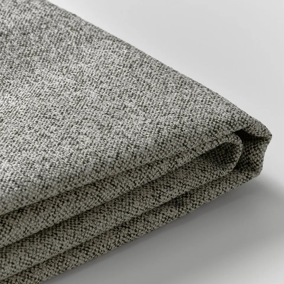 Close-up of soft, textured grey fabric, likely a recycled polyester blend, folded neatly. Shows quality and detail of upholstery material.