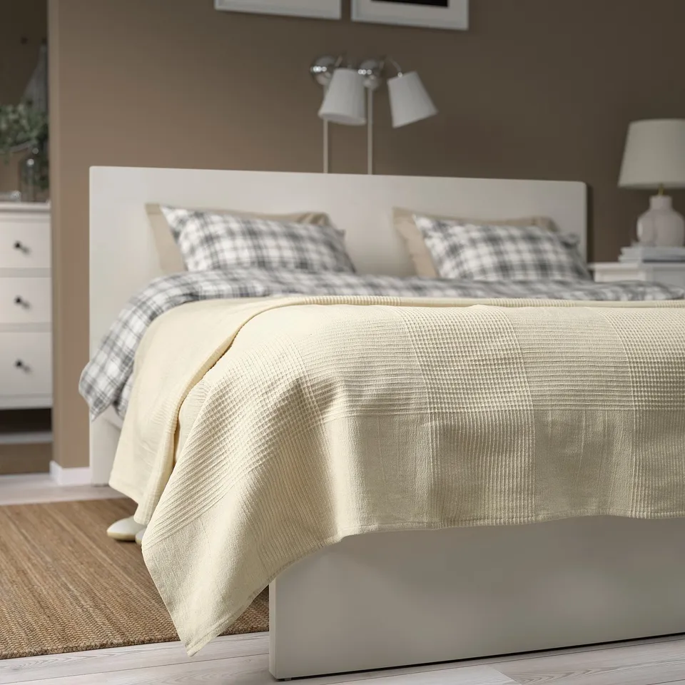 INDIRA off-white cotton bedspread with wood furniture