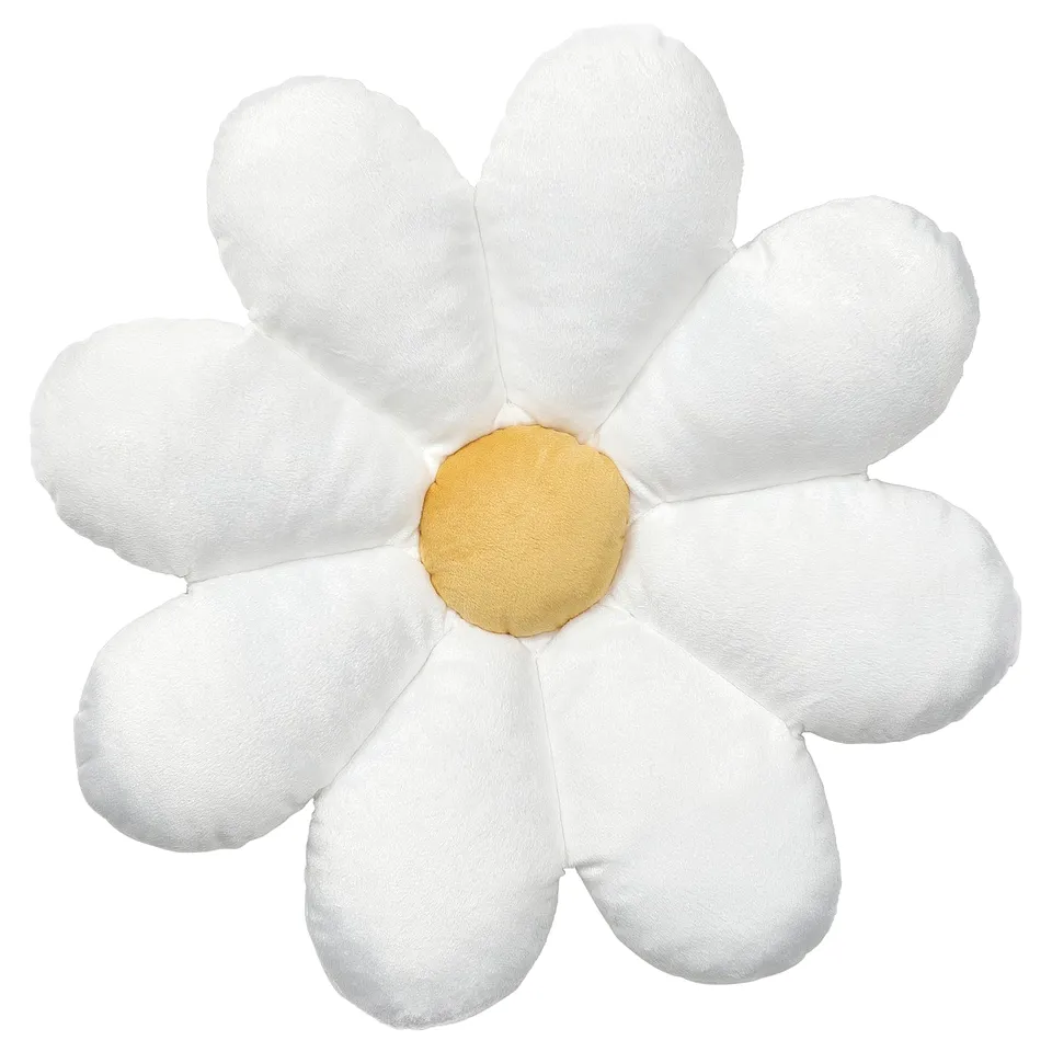 White, soft, star-shaped pillow, yellow centre, made from recycled polyester.