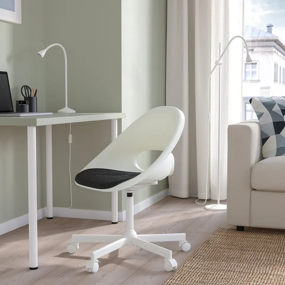 LOBERGET office chair & desk. Ergonomic, adjustable, compact. Modern lamp completes clean workspace.