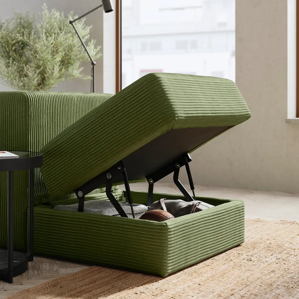 Green JÄTTEBO sofa with storage compartment open, revealing items inside. Modern, modular design in corduroy fabric.