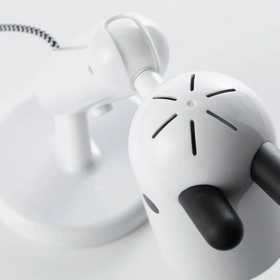 Adjustable white lamp with spherical face and black handle, showcasing quality design.