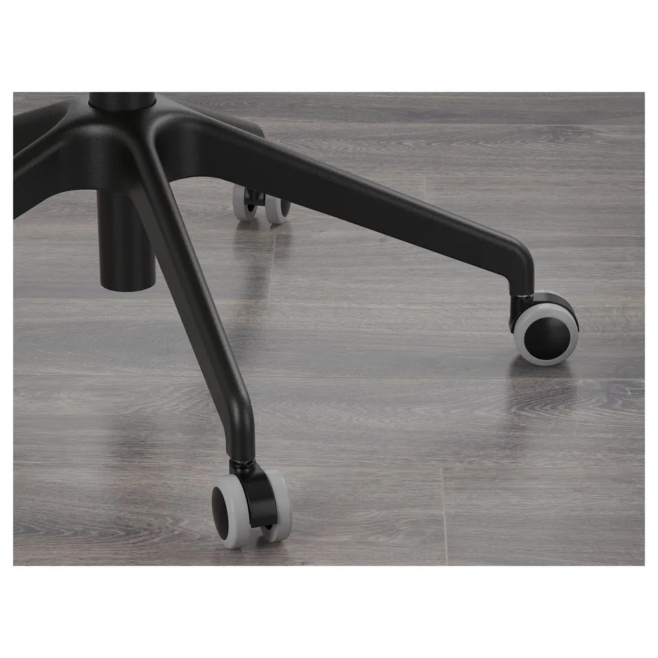 Close-up of office chair base showing durable black armrests and smooth-rolling casters on wooden floor.
