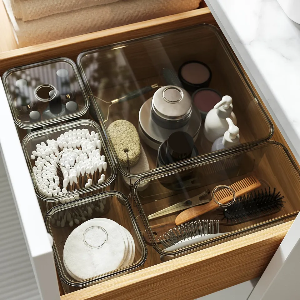 Organised drawer with containers: cotton swabs, hair accessories, and more. Keeps bathroom essentials neat and easily accessible.