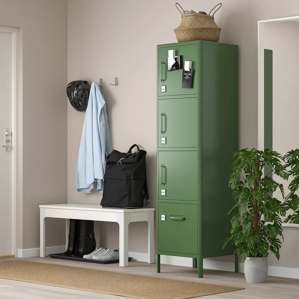 Green IDÅSEN locker beside white bench, with multiple drawers and accessories nearby.