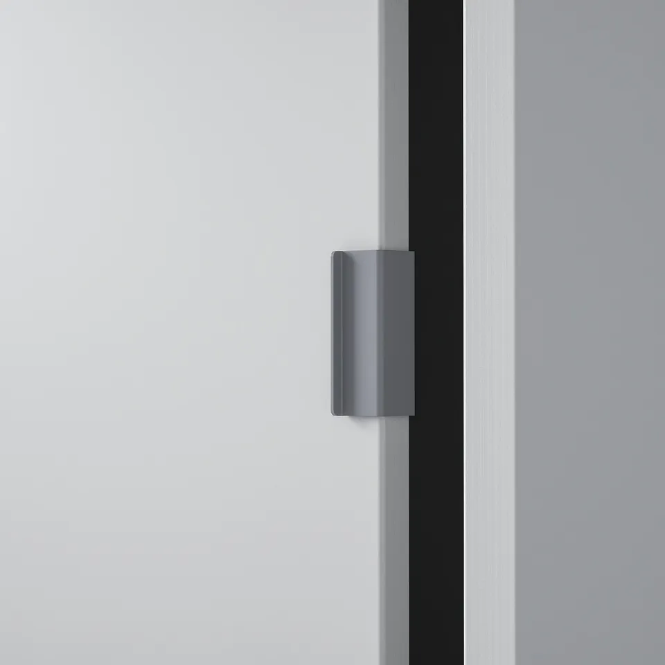 Grey modern handle on sleek, smooth surface, showcasing minimalist design.