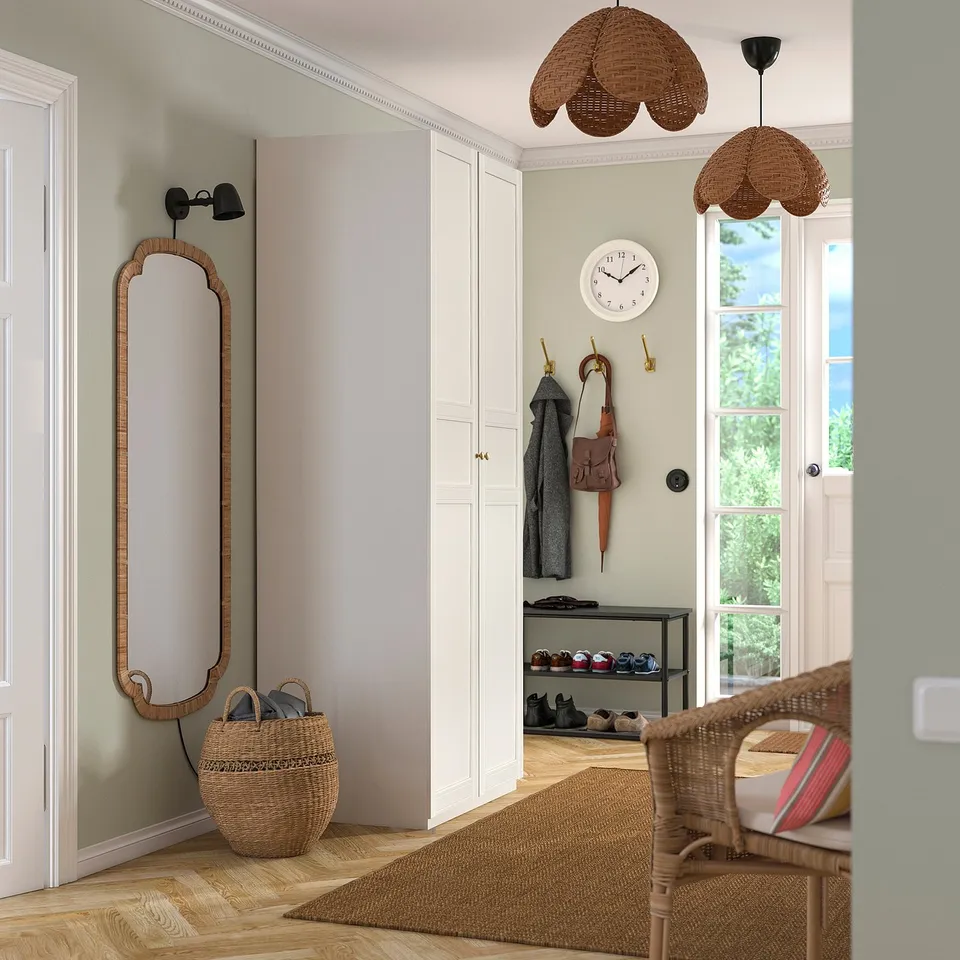 Entryway with white PAX wardrobe, mirror, pendant light, shoe rack, and baskets.