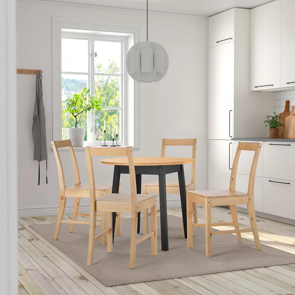 Modern white/wood dining set PINNTORP in minimalist kitchen with pendant lamp.