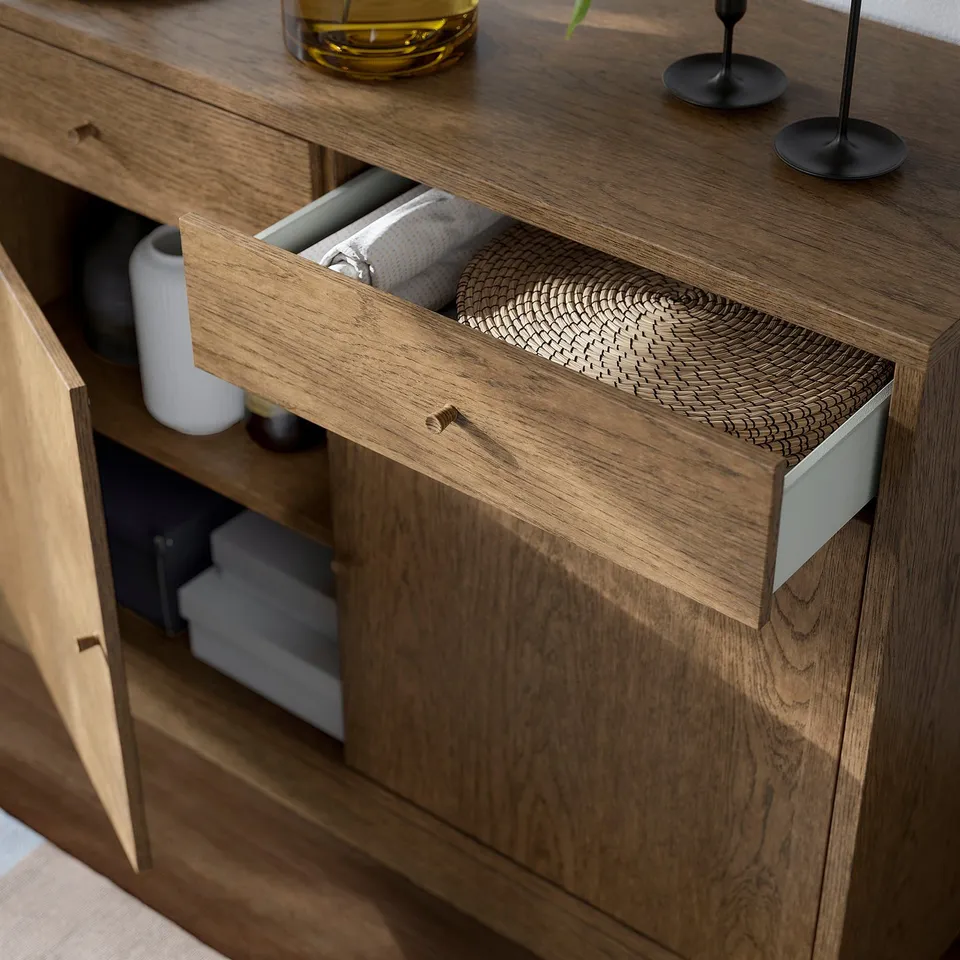Wooden TONSTAD cabinet with open drawer, wicker basket, and decorative items.