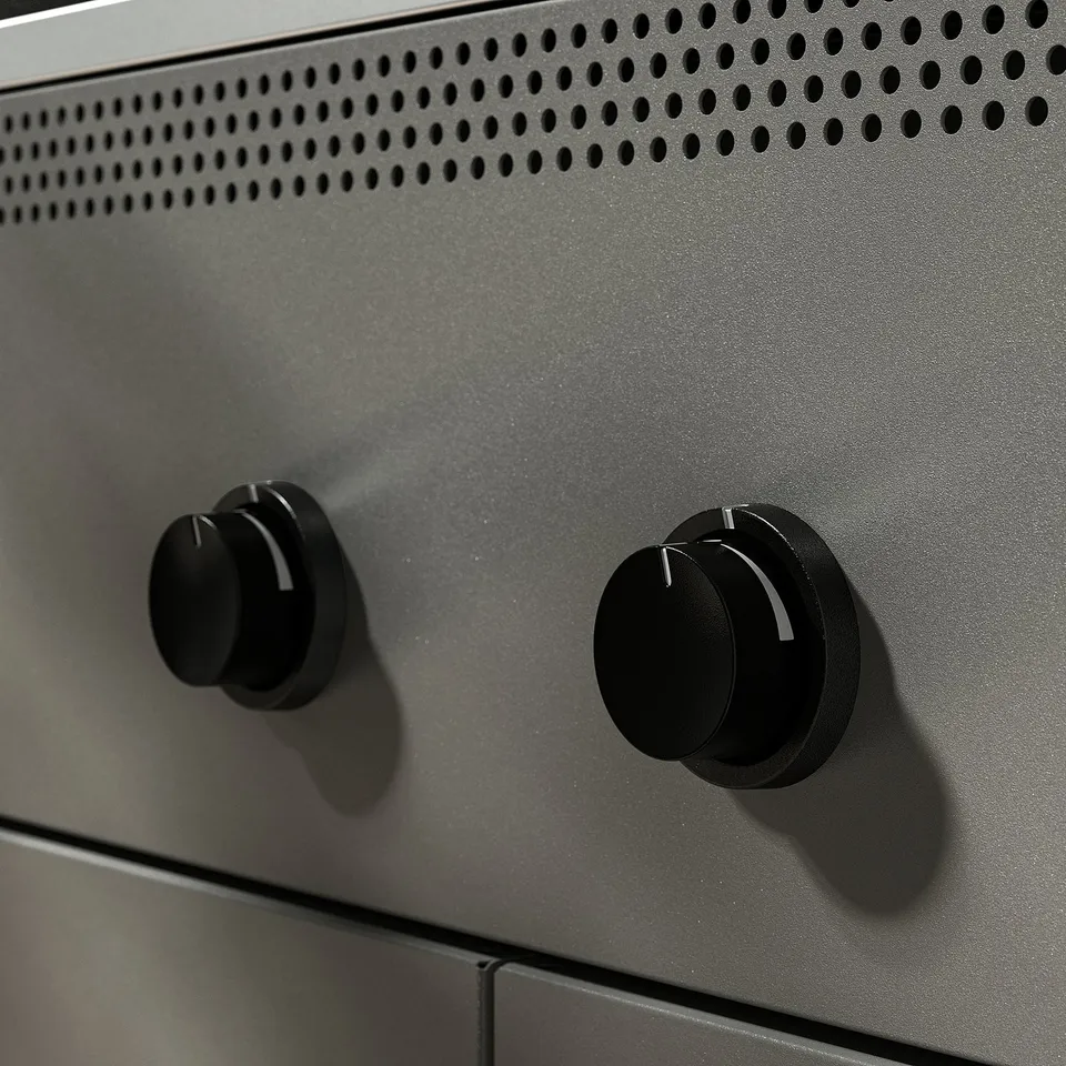 Modern outdoor grill with two ventilation knobs, sleek grey body, and stainless steel accents, showcasing high-quality construction and design.