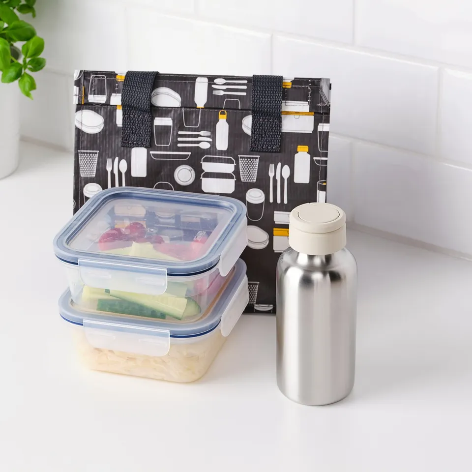 A water bottle with a carry handle and a stack of food containers on a white countertop.